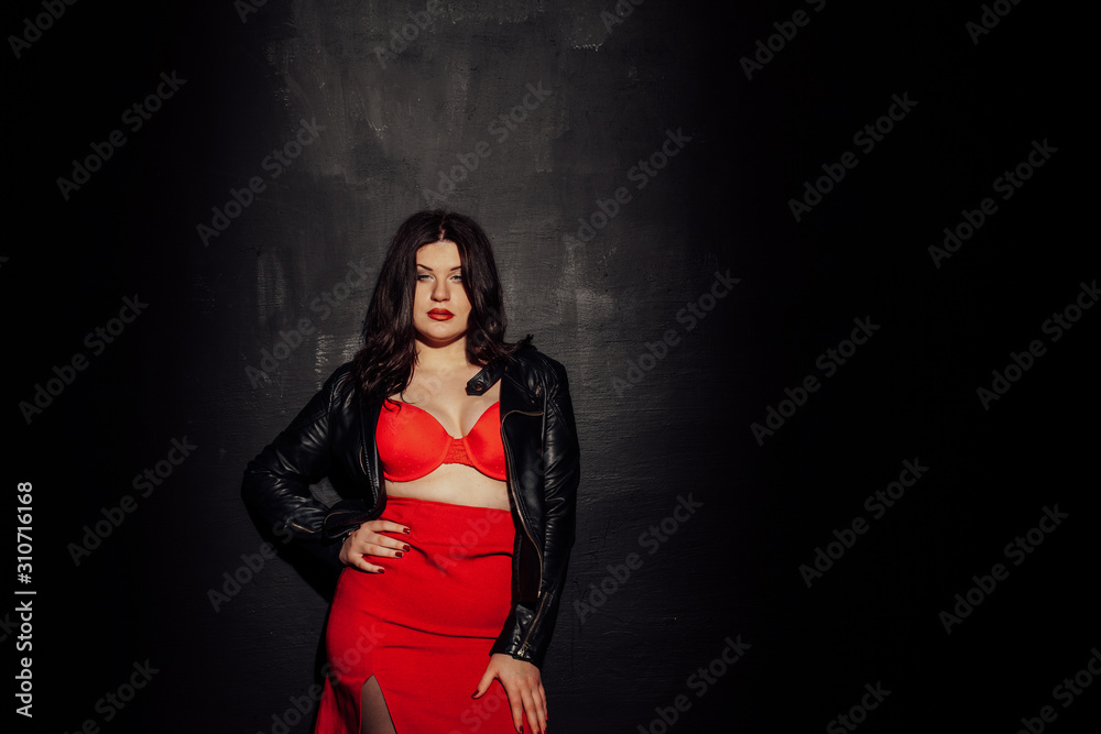 Fototapeta premium fat woman in red underwear in black room