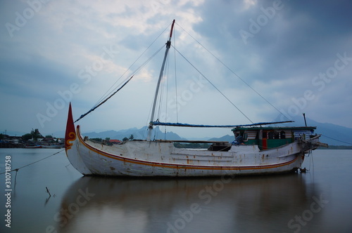Traditional fishing vessels that still use traditional fishing gear, this boat is made of wood that is resistant to sea water. Fishing boats dock at the seashore.