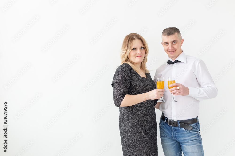Holidays, christmas, valentine's day and new year concept - Woman and man celebrate and holds wine in a glass over white background with copy space Holidays, christmas, valentine's day and new year concept - Woman and man celebrate and holds wine in a glass over white background with copy space