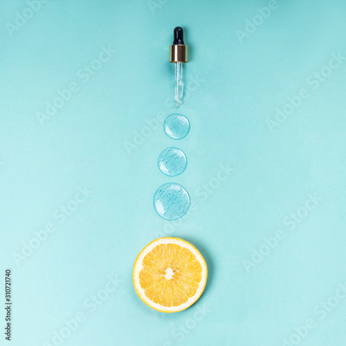 Medical dropper of hyaluron on a blue background Vitamin C medical concept photo