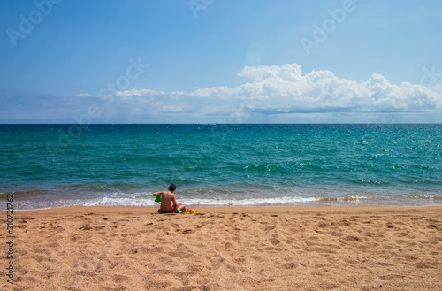 Caucasian boy playing on the beach