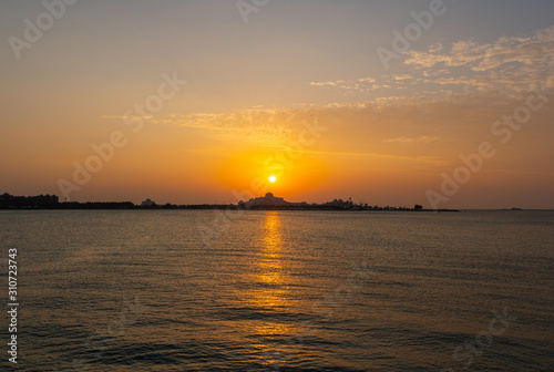Beautiful sunset with lights reflections on the water 