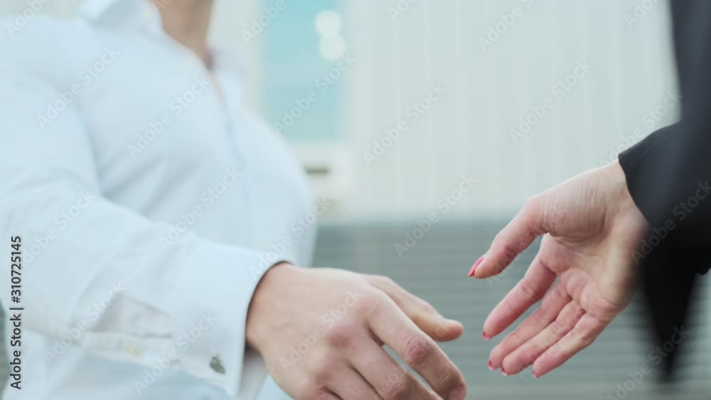 Handshake Of Man And Woman. Consolidation Of Business Agreement. Handshake Of Man And Woman. Consolidation Of Business Agreement.