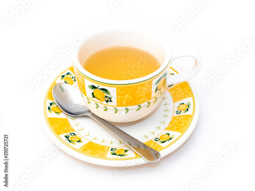 Green tea ceramic cup with teaspoon isolated