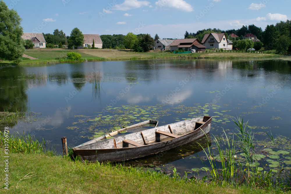 Fototapeta premium Wooden boat on a lake outside Ignalina, Lithuania