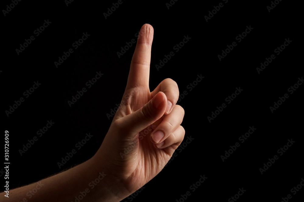 Numbers 1 in sign language. gesture number 1. hand gesture pay attention. women hand sign isolated on black background. finger pointer Numbers 1 in sign language. gesture number 1. hand gesture pay attention. women hand sign isolated on black background. finger pointer