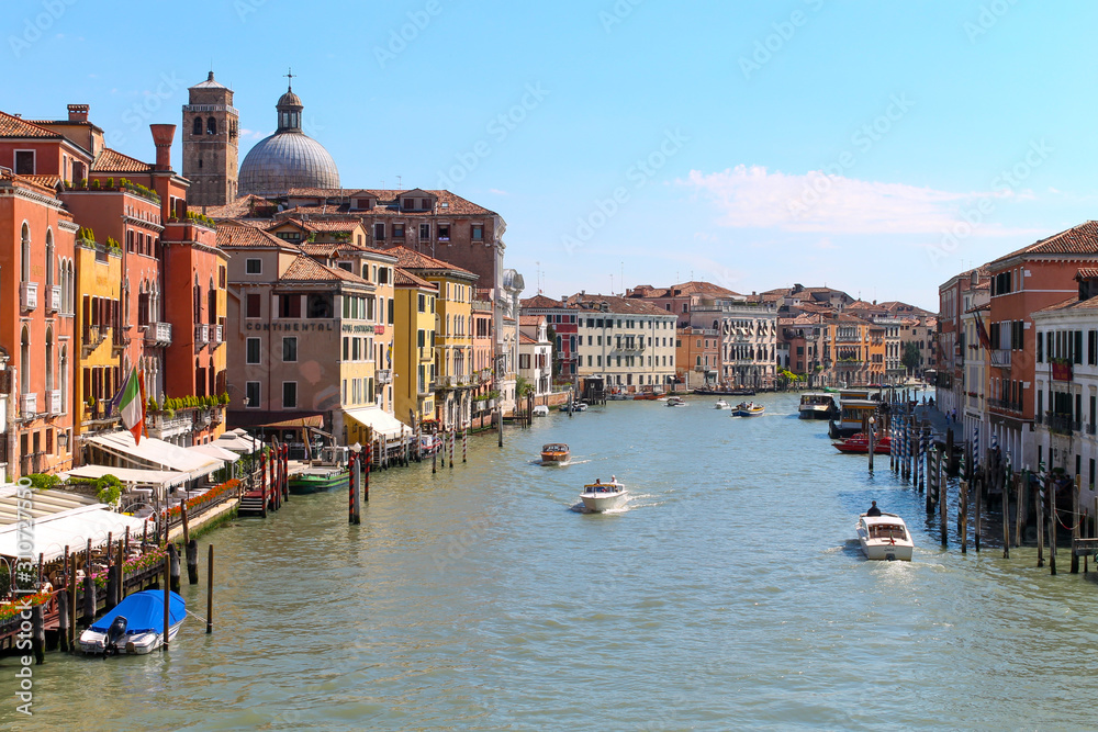 Grand canal in Venice, Italy showing great architecture, water, city, sea boat. Shot at bright summer day. Tourist destination. 