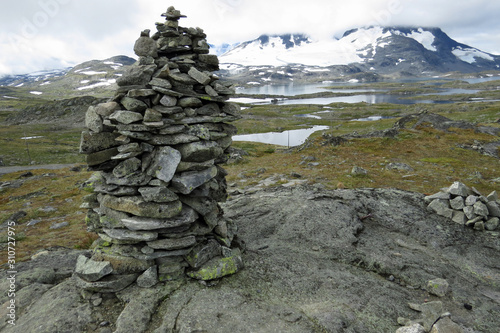 Troll stone tower in front of the beautiful mountain and tundra landscape with snow dots and little laeks on the Snovegen "the snow street" , the Aurlandsfjellet, a scenic route between Laerdal and Au © Thomas