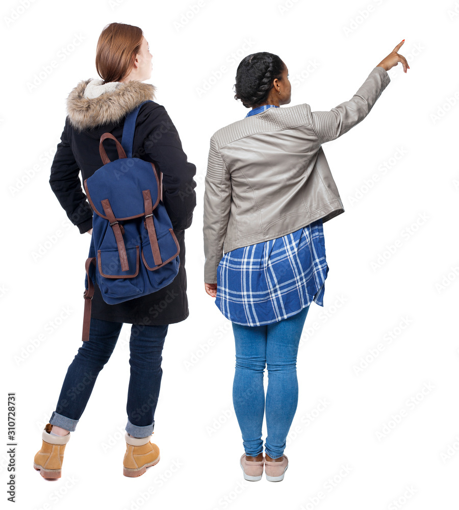 Back view of two pointing young girl in winter jacket. Back view of two pointing young girl in winter jacket.