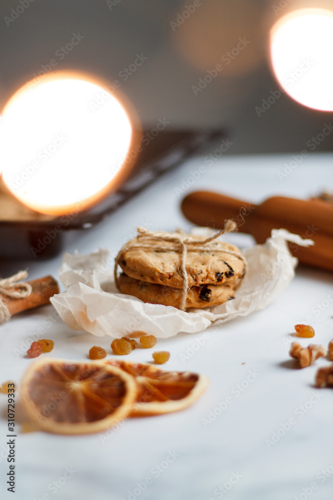 Christmas composition. cookies tied, rolling pin, cinnamon, cookies and dried orange, nuts, raisins. Christmas composition. cookies tied, rolling pin, cinnamon, cookies and dried orange, nuts, raisins.