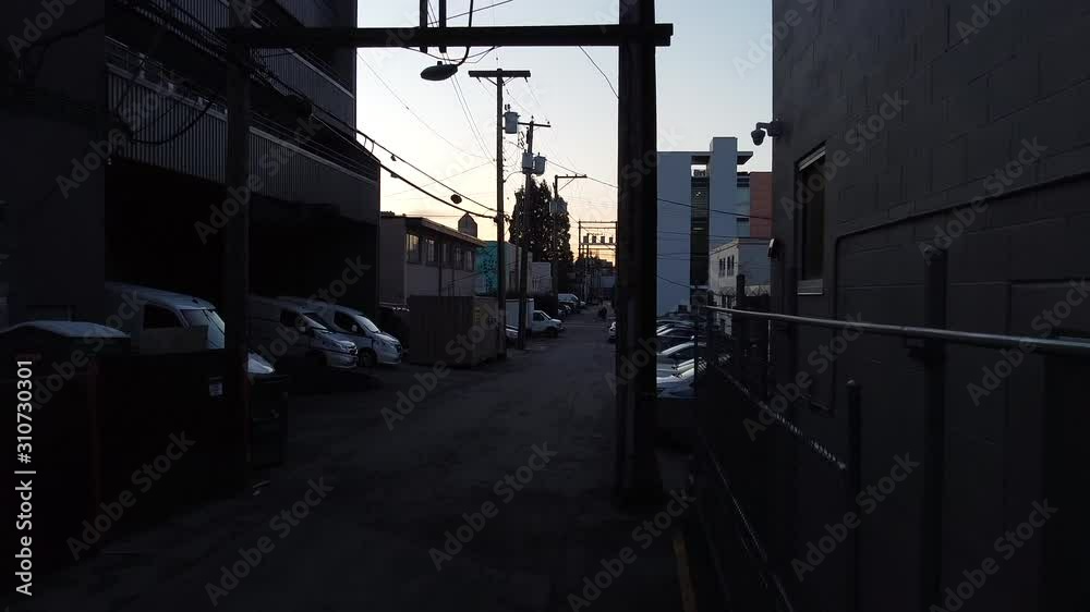 Electricity poles and communications in the alley during sunset Electricity poles and communications in the alley during sunset