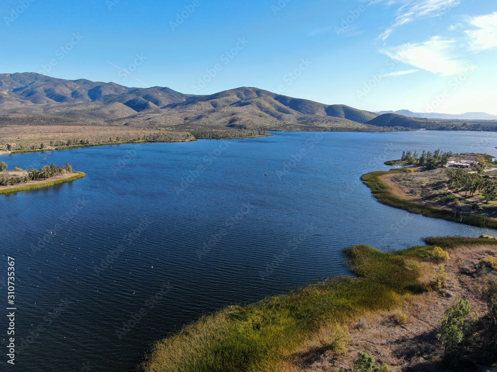 Aerial view of Otay Lake Reservoir with blue sky and mountain on the background, Chula Vista, California. USA