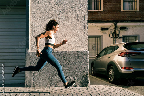 Fitness woman jogging outdoors in the city photo