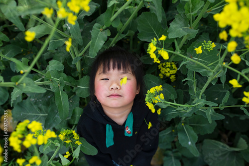 Happy little asian girl in spring field
