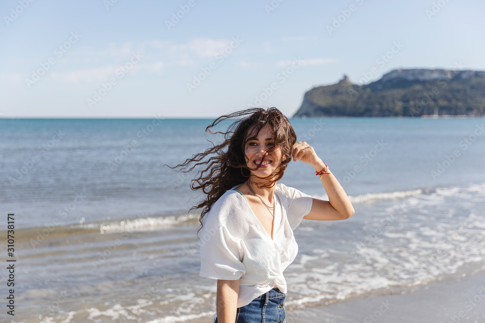 Smiling brunette having fun at the sea Smiling brunette having fun at the sea