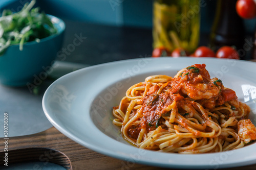 Mouth-watering pasta with tomato sauce and shrimps photo