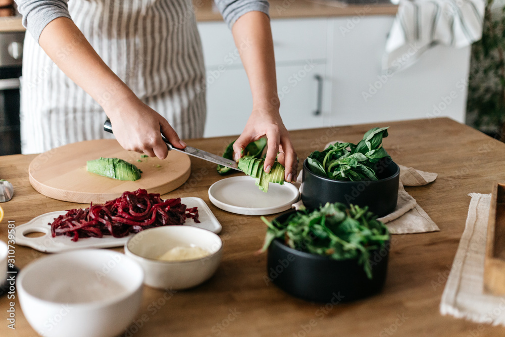 Anonymous cutting avocado for meals Anonymous cutting avocado for meals