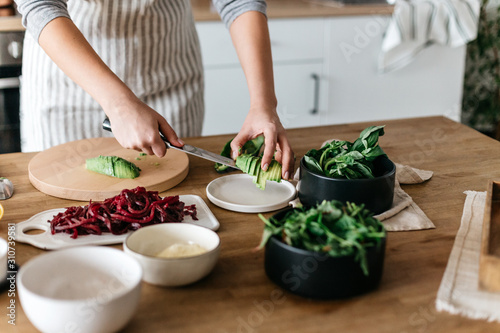 Anonymous cutting avocado for meals