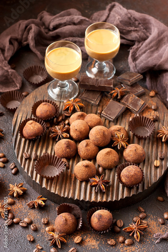 Composition with chocolate truffles and little glass with sweet liqueur