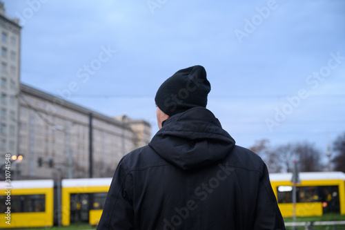 Rear view of a man looking at something. Berlin, Germany.