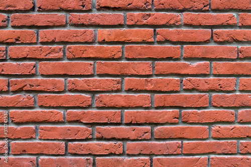 Weathered stained red old brick wall background, bright texture. Copy space