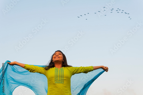 Teenage Girl Making Fun With Churni At Outdoors photo