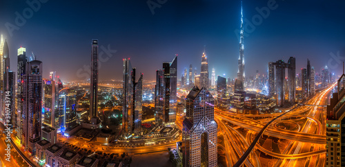 Dubai skyline during sunrise with shining traffic road, United Arab Emirates. photo