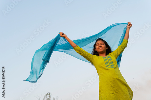 Teenage Girl Making Fun With Churni At Outdoors photo