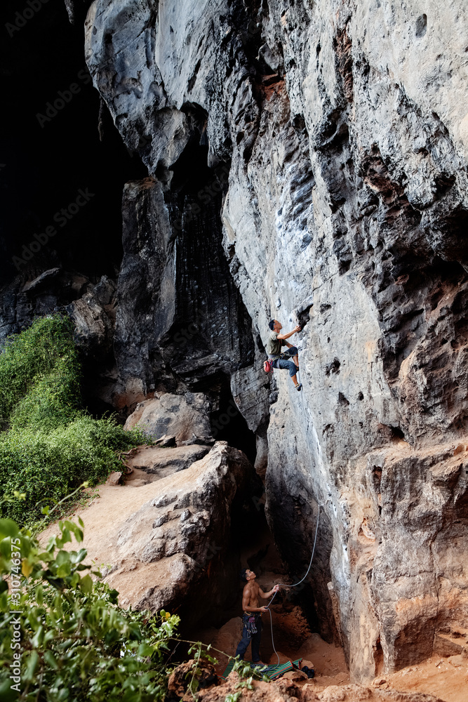 Climbers training on cliff providing insurance Climbers training on cliff providing insurance