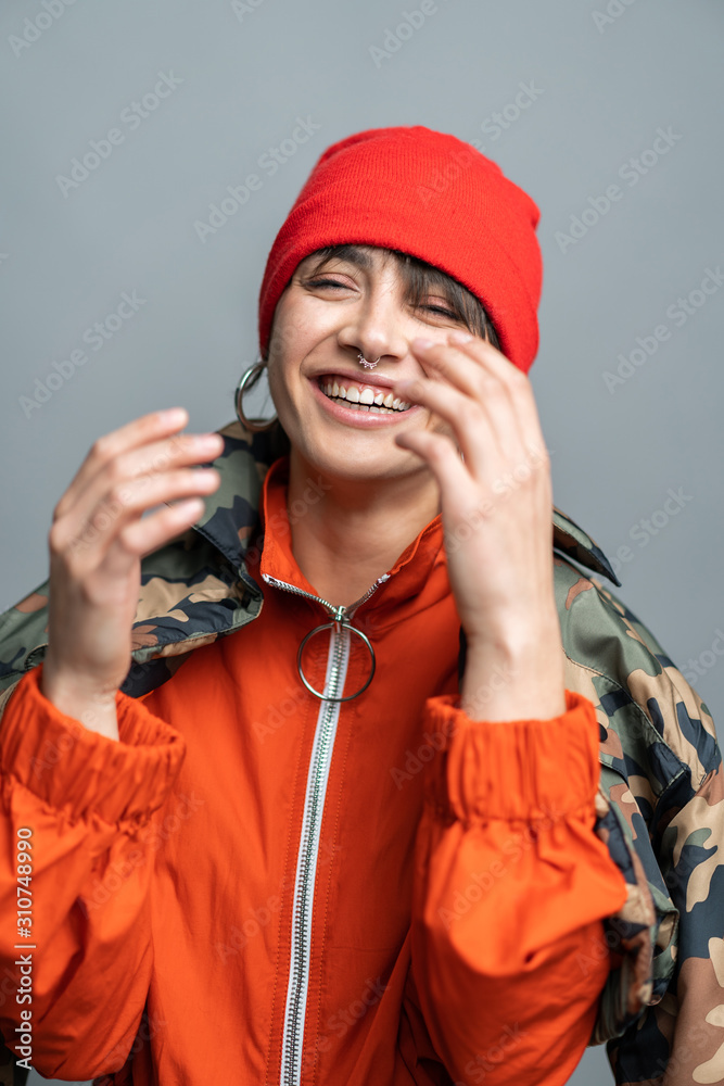 Laughing contemporary girl in hat and earrings Laughing contemporary girl in hat and earrings