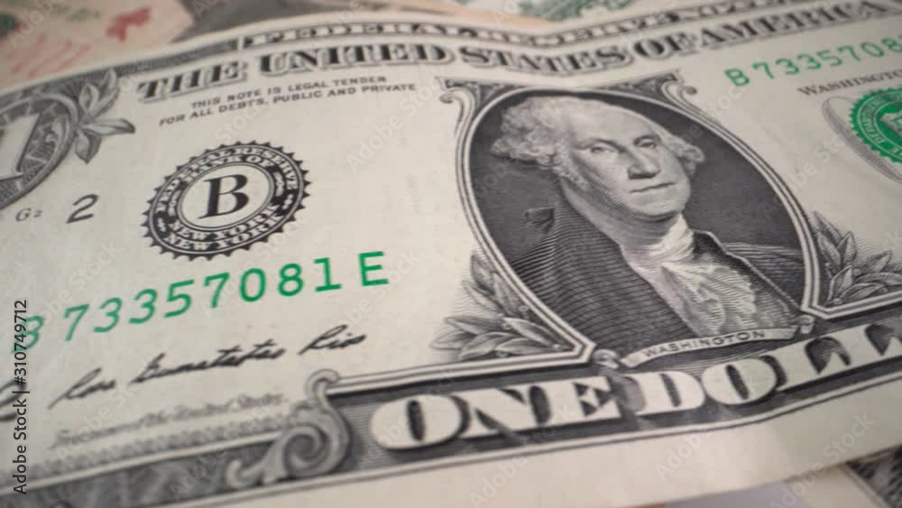 One dollar bill rotates on a table. Close-up One dollar bill rotates on a table. Close-up