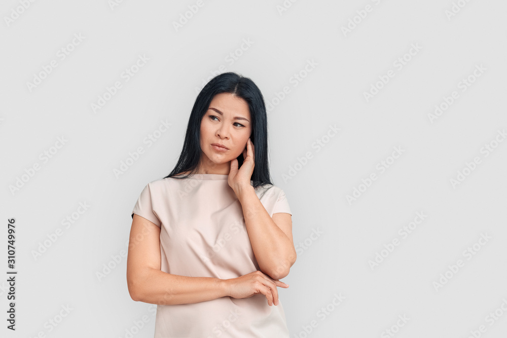 Freestyle. Asian woman standing isolated on white looking aside concerned Freestyle. Asian woman standing isolated on white looking aside concerned
