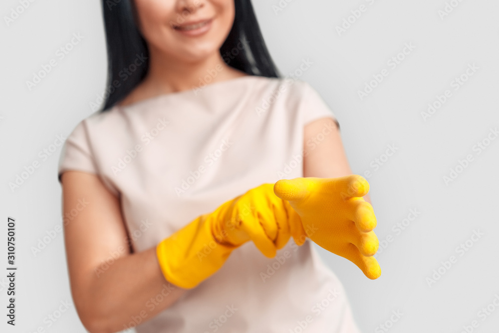 Freestyle. Asian woman putting on gloves standing isolated on white close-up blurred smiling happy Freestyle. Asian woman putting on gloves standing isolated on white close-up blurred smiling happy