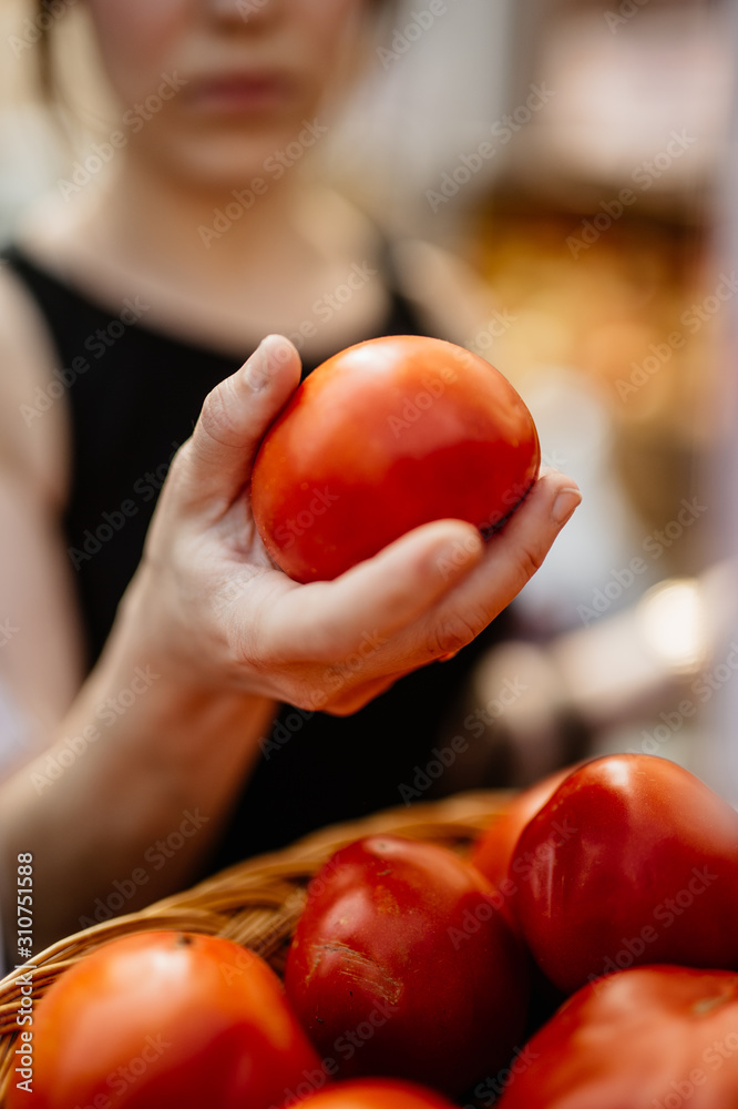Woman Examining Tomatoes At Farmers Market