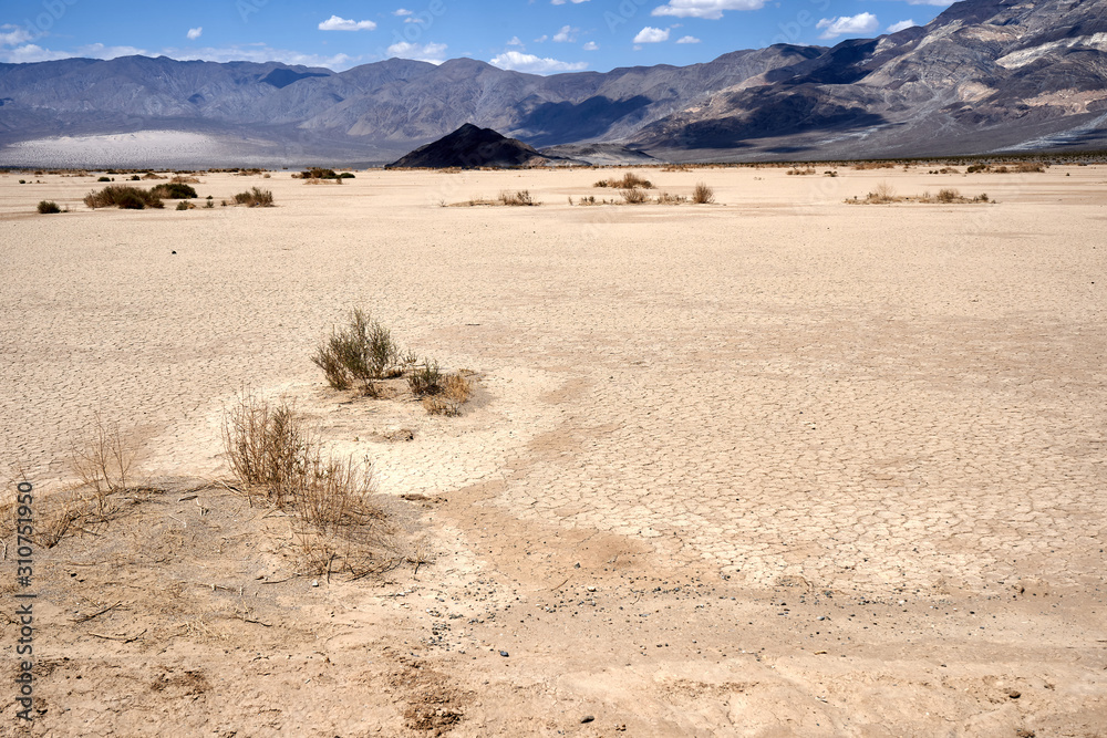 Mojave Desert. In southern California, southeast of Sierra Nevada, north and east of Los Angeles, North America. Rocks are brown and gray. Clouds in the blue sky