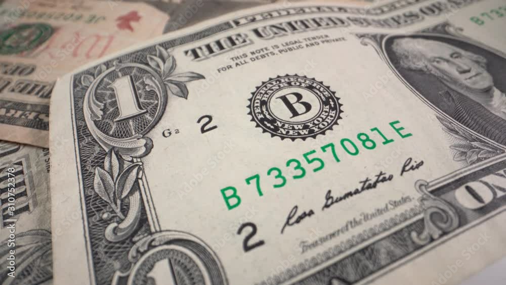 One dollar bill rotates on a table. Close-up One dollar bill rotates on a table. Close-up