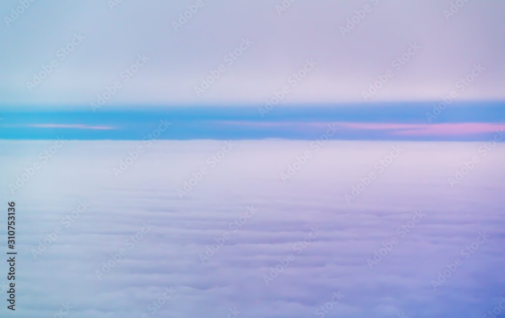 Purple sunrise or sunset above the clouds
