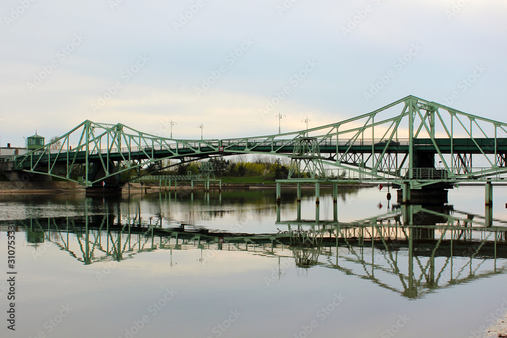 green swivel bridge over the river