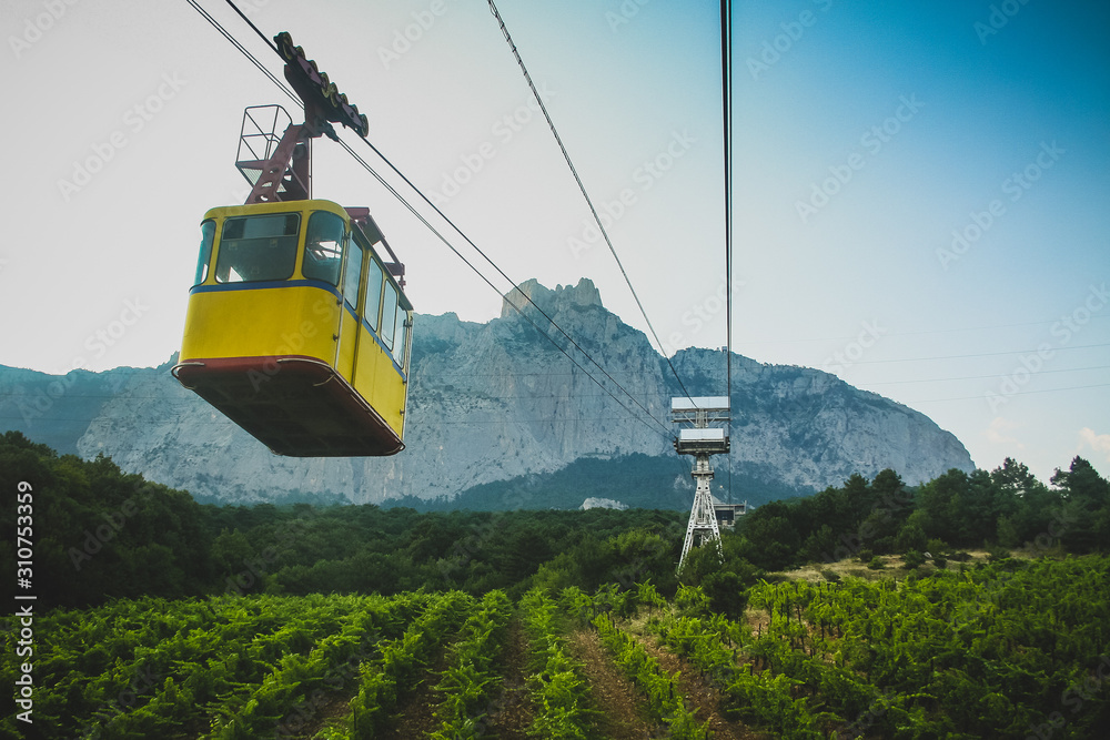 Yellow cable car or gondola under the Ay Petri mountain in southern crimea, close to Yalta in Ukraine.