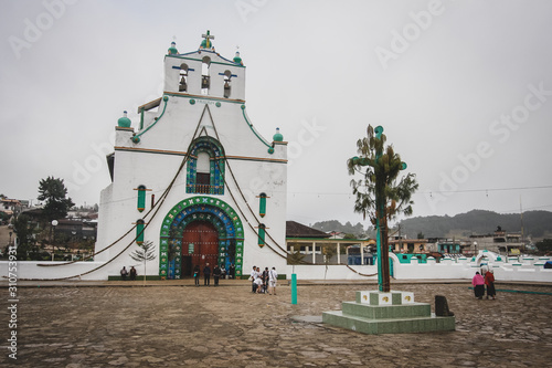 San Juan Chamula church in the village of San Juan, just above the San Cristobal de las Casas. Overcast day, with cross visible in the foreground. photo