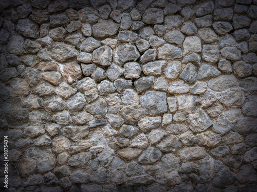 Dark stone wall background with vignette