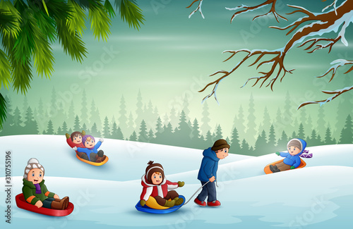 Happy children playing sledding in the snow