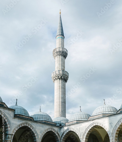 Amazing tower of mosque and blue heaven. Minaret of the Suleiman Mosque. photo