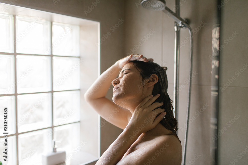 Young woman taking a shower Young woman taking a shower