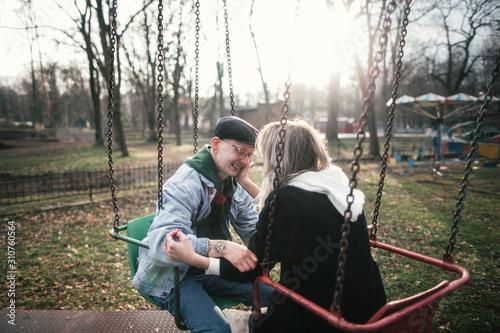 young couple on a swing photo