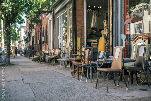 Street View of Commercial Street in Williamsburg Brooklyn with Old Chair of Junk Shop on Sidewalk photo