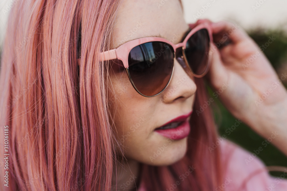 Retro colorful woman adjusting sunglasses Retro colorful woman adjusting sunglasses