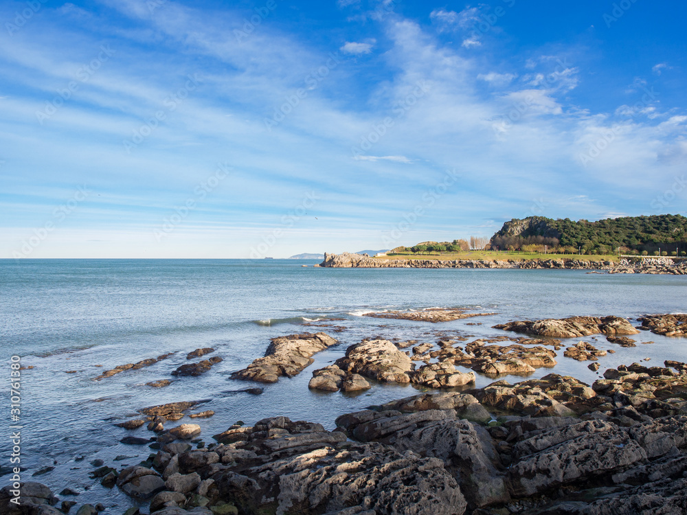 Landscape on the coast of Castro Urdiales, Cantabria, with rocks and horizon line at sea