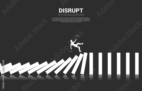 Silhouette of businessman falling on collapse domino. business concept of business disruption and domino effect