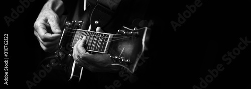 Guitarist hands and guitar close up. playing electric guitar.  black and white. copy spaces